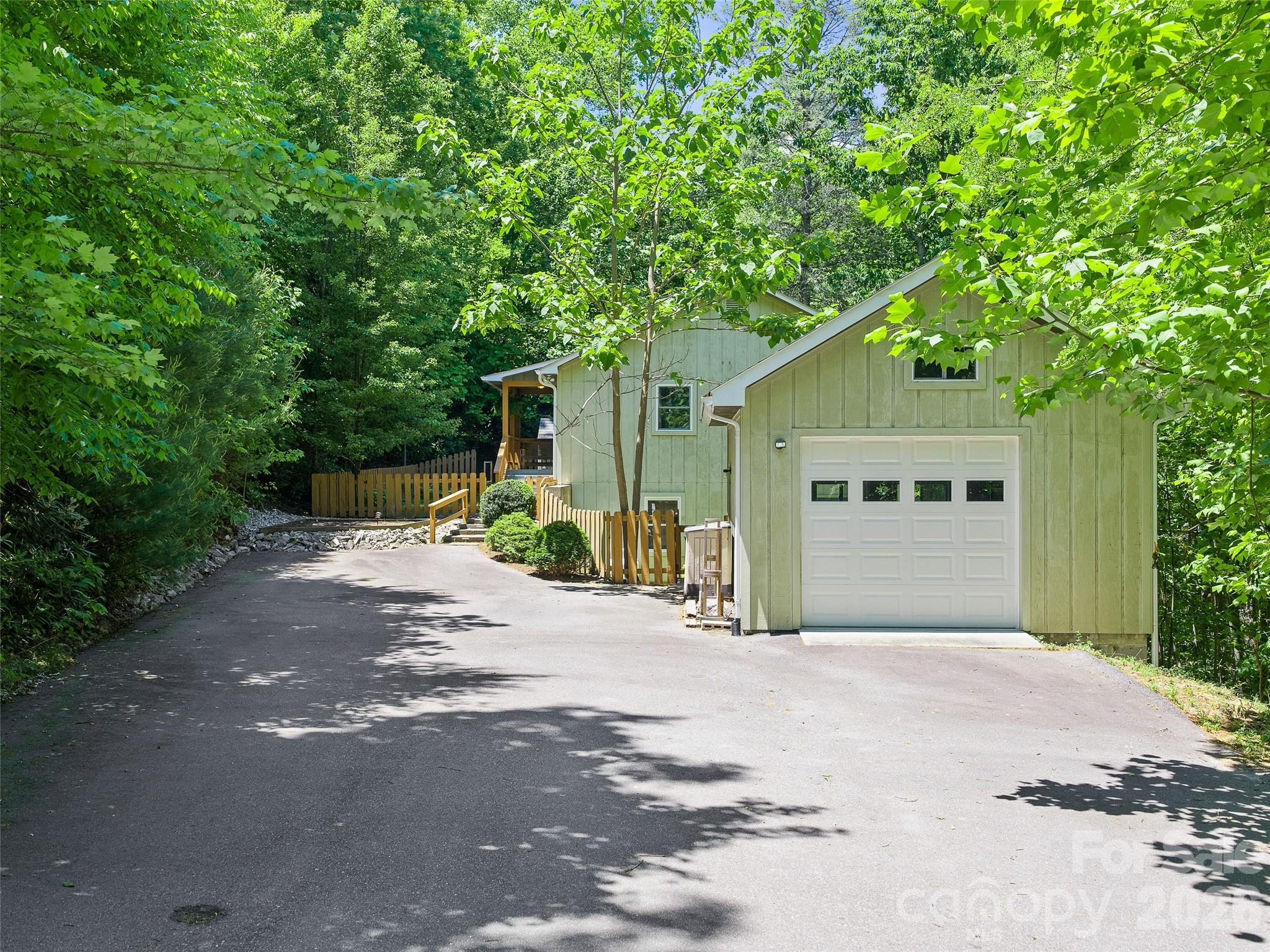 142 Wildflower Road Spruce Pine, NC 28777 - Photo 32 of 46 a front view of a house with a yard and garage