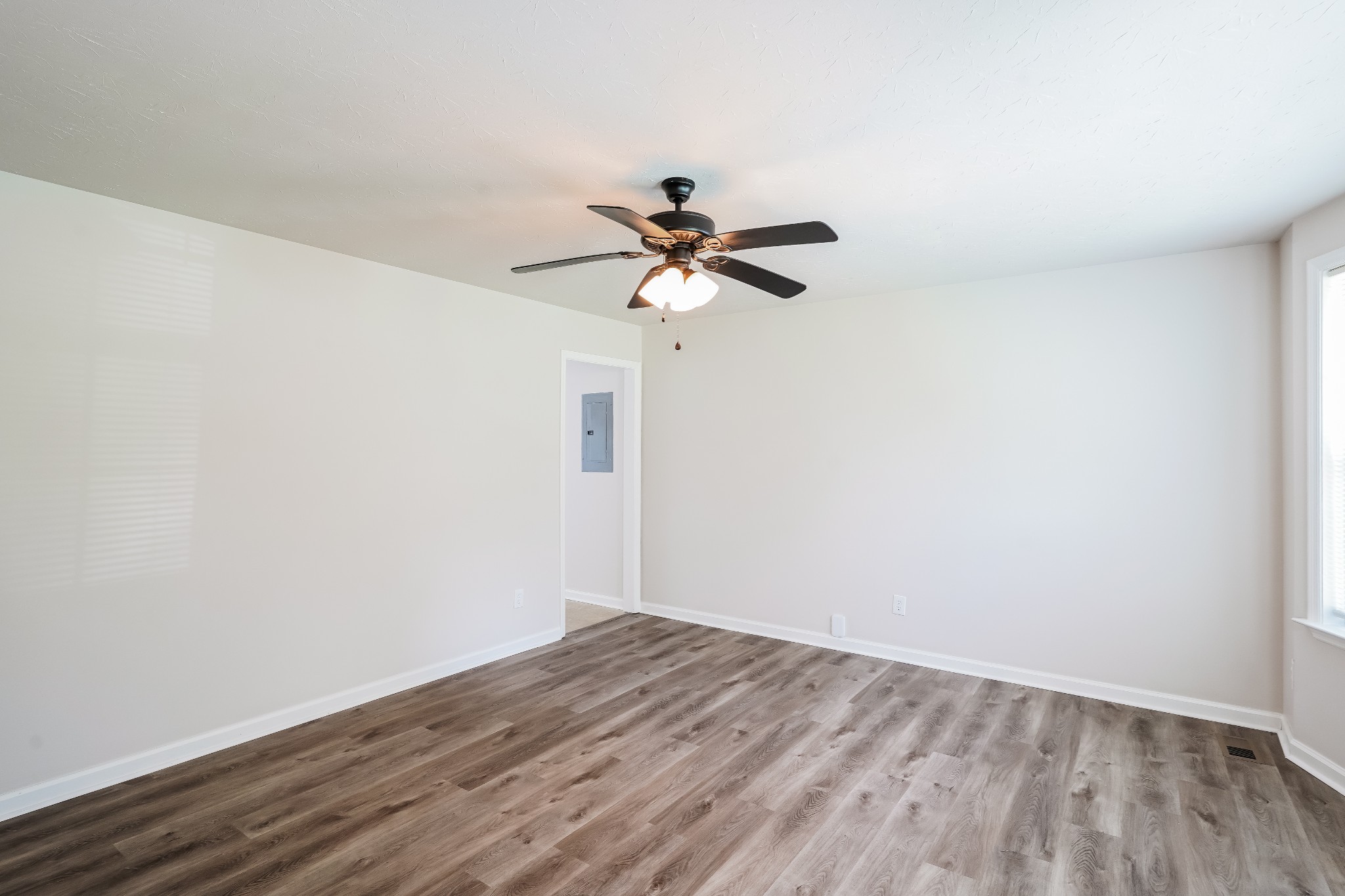 1028 William Glen Road Ashland City, TN 37015 - Photo 8 of 16 a view of a room with wooden floor and a ceiling fan