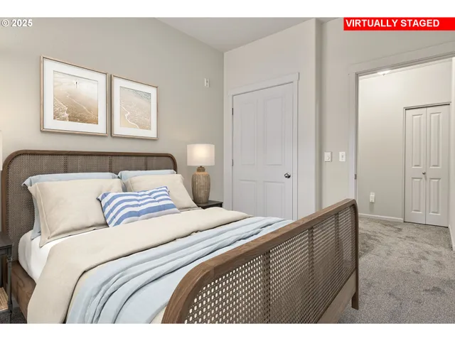 a bedroom with a bed and a painting on the wall