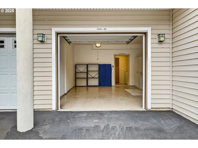 a view of a hallway with wooden floor and windows