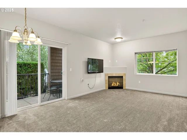 a view of empty room with windows and fireplace