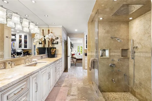 a bedroom with a bed dresser and a large window