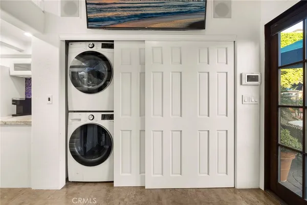 a view of patio with chairs and table under an umbrella