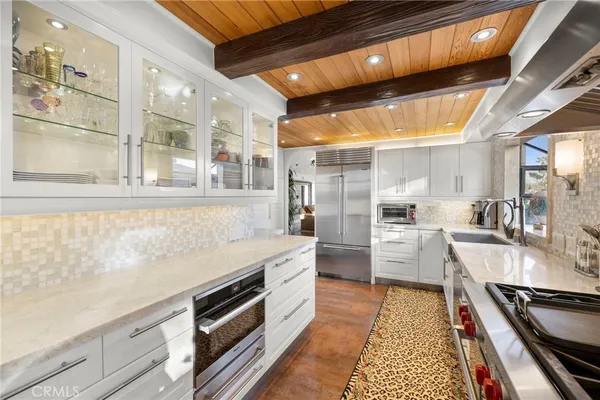 a kitchen with stainless steel appliances a stove a sink and a refrigerator