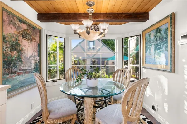 a dining room with furniture window and wooden floor