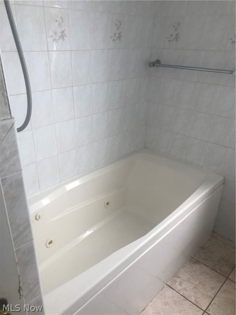 4037 Wilmington Road Cleveland, OH 44121 - Photo 23 of 36 Full bathroom featuring a whirlpool tub and light tile patterned floors