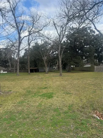 a view of a swimming pool and trees in the background