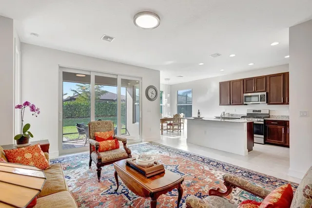 a living room with furniture and a kitchen