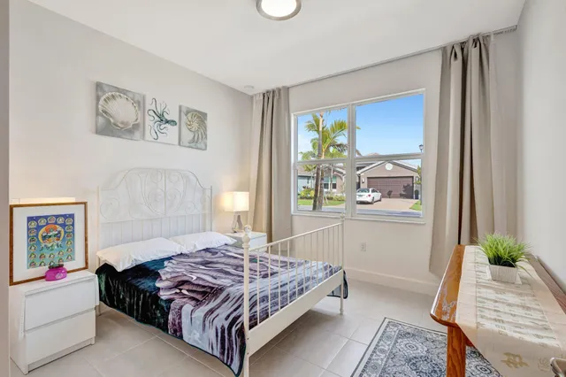 a bedroom with a bed table and a window