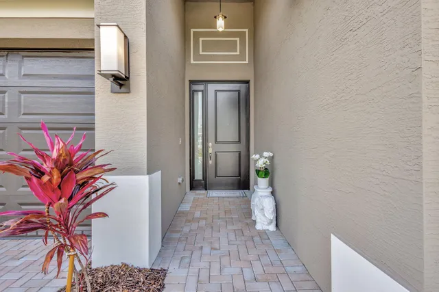 a view of a hallway with wooden floor and a potted plant