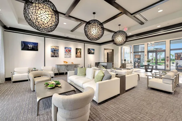 a living room with furniture a large window and a clock