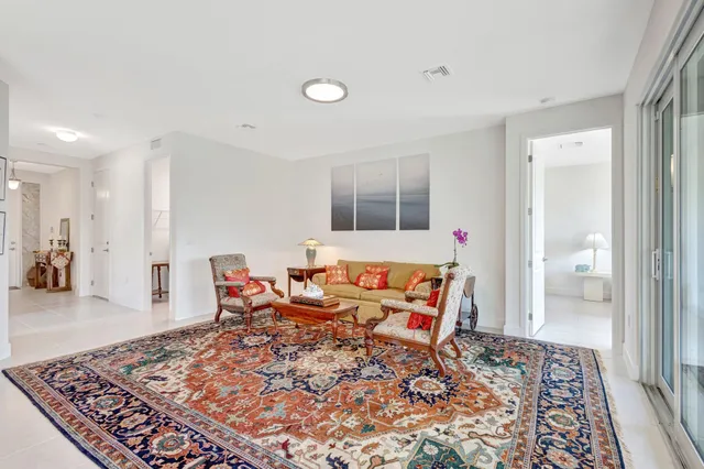 a bedroom with furniture and a rug