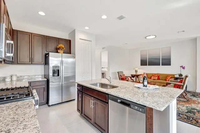 a kitchen with stainless steel appliances granite countertop a sink and refrigerator