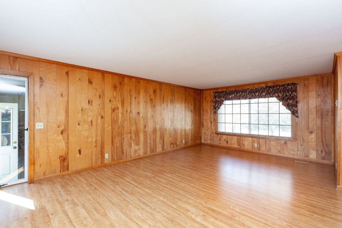 2102 Center Point Road Hendersonville, TN 37075 - Photo 15 of 50 an empty room with wooden floor and windows with curtains