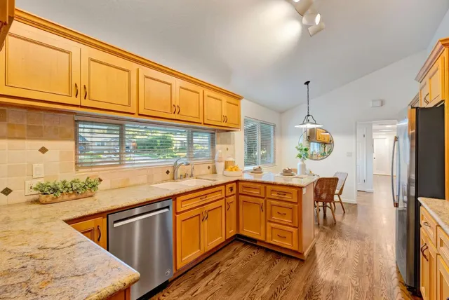 a kitchen with a sink stove and wooden cabinets