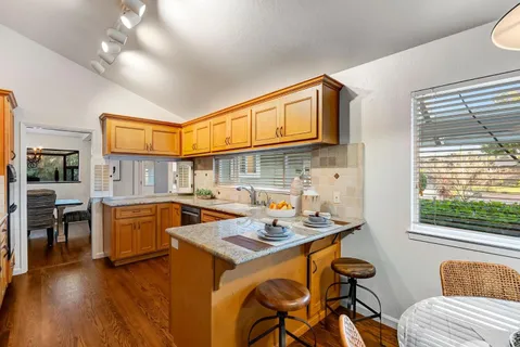 a open kitchen with a sink cabinets and wooden floor