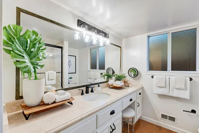 a bathroom with a double vanity sink and a mirror