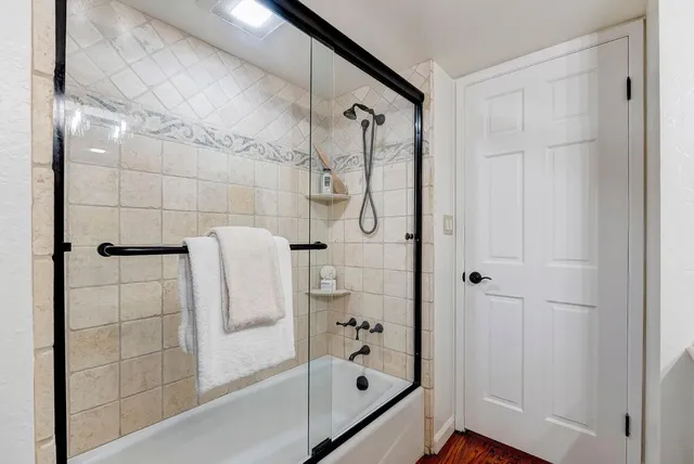 a bathroom with a bathtub and a shower