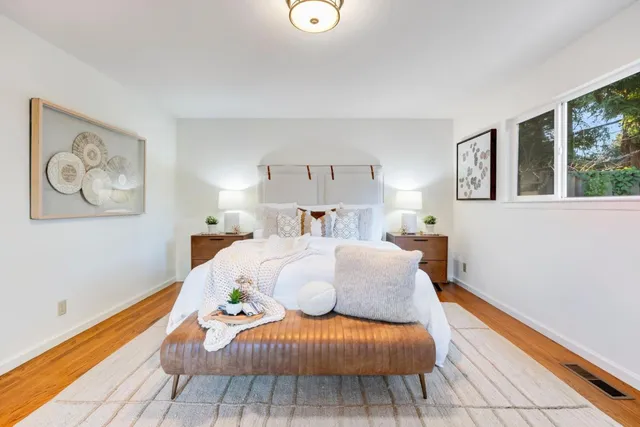 a bedroom with a bed and wooden floor