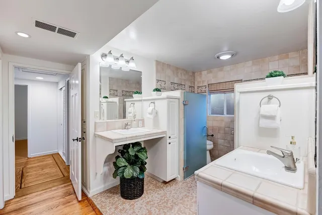 a bathroom with a sink double vanity and a mirror