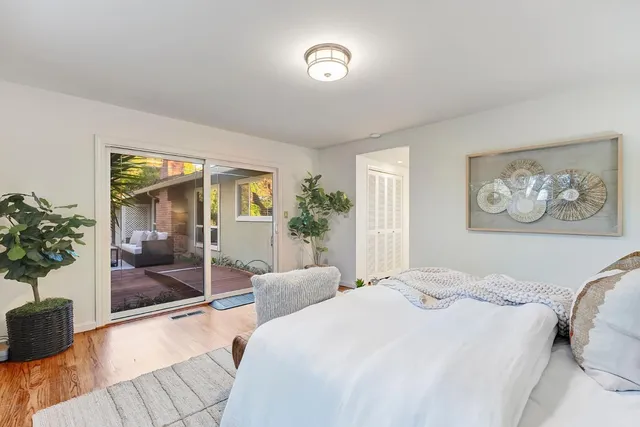 a bedroom with a large bed and a chandelier