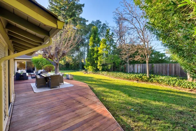 a view of a house with backyard and sitting area