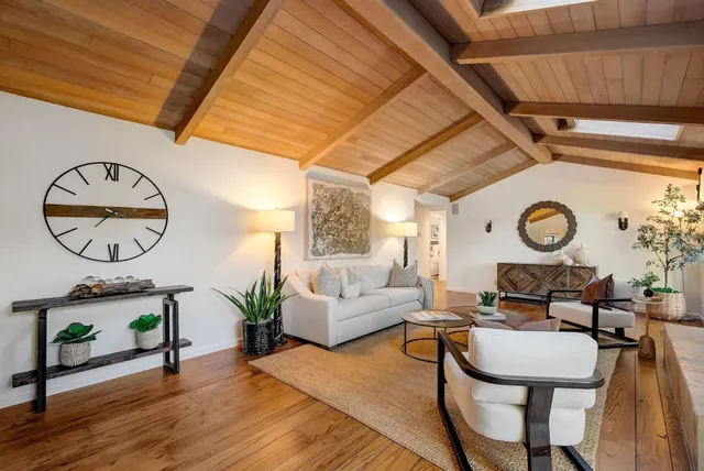 a living room with furniture a rug and a table