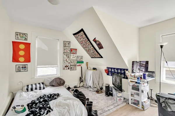 a bedroom with a bed and a window