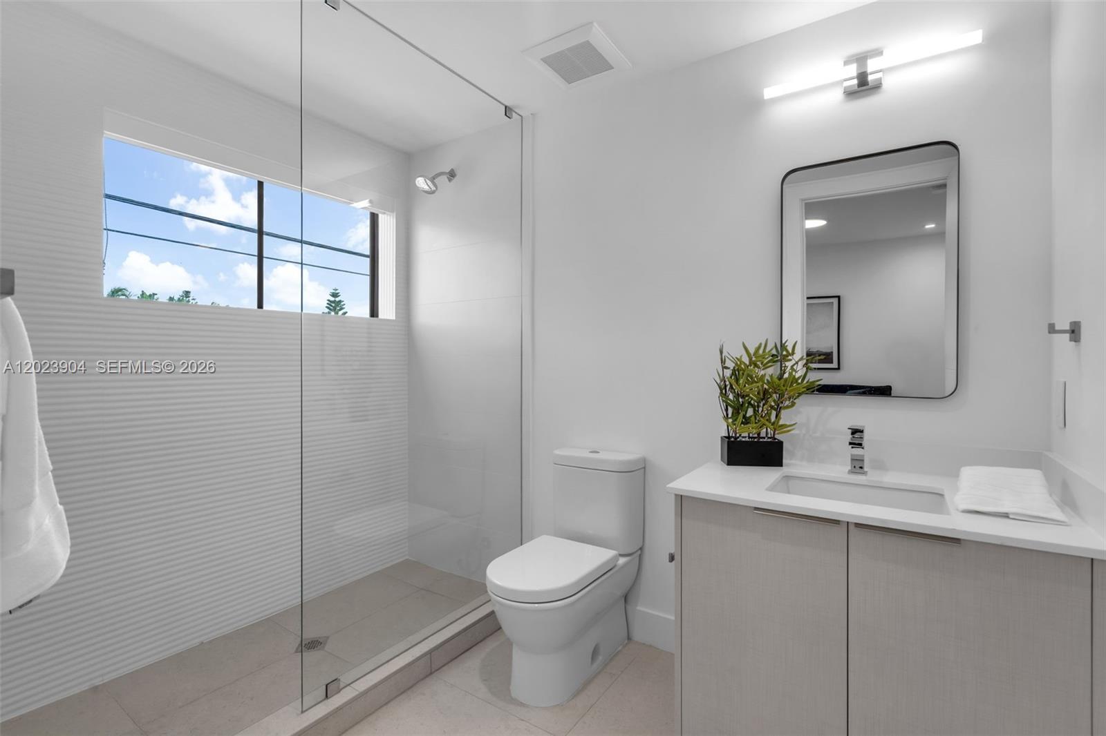721 Southwest 11th Street, Unit G Miami, FL 33129 - Photo 17 of 40 a bathroom with a toilet a sink and shower