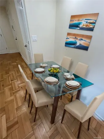a view of a dining room with furniture and wooden floor