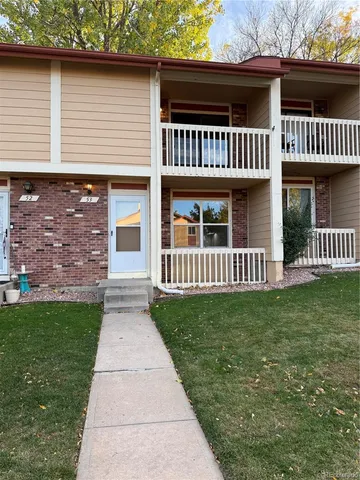 a view of a house with a yard and porch
