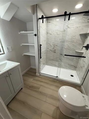 a bathroom with a toilet and a shower
