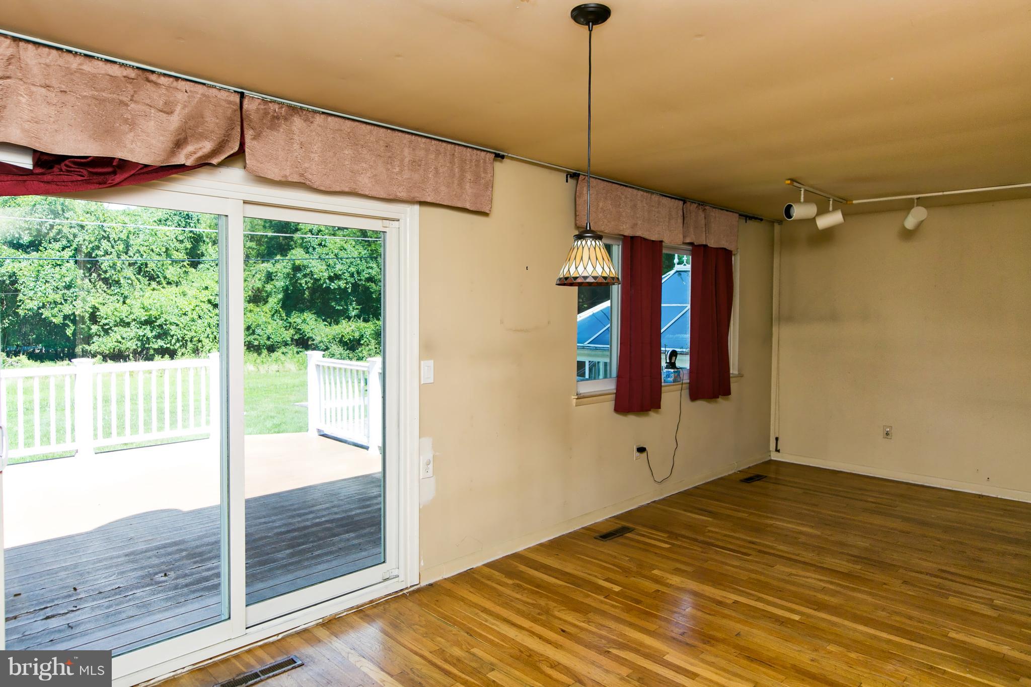 4624 Hawksbury Road Baltimore, MD 21208 - Photo 9 of 22 Sliders off dining room lead to beautiful trex dec