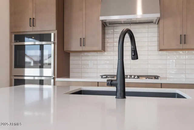 a kitchen with granite countertop a sink and a stove