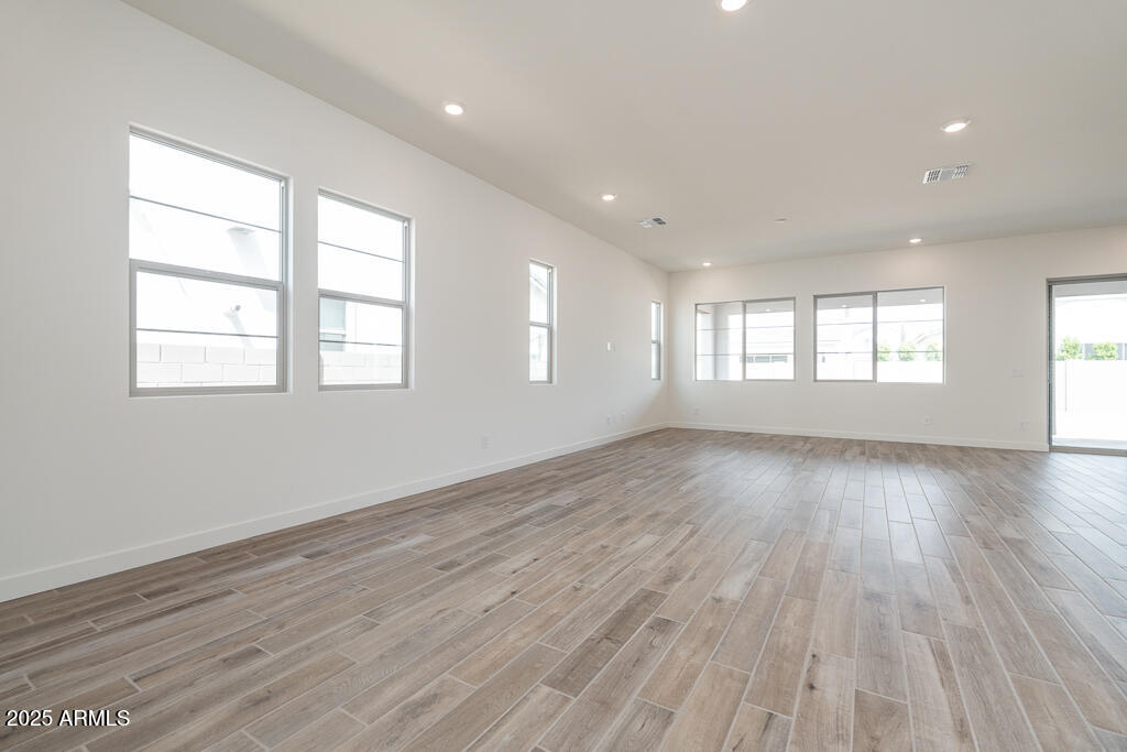1342 East Prescott Street Gilbert, AZ 85298 - Photo 5 of 21 an empty room with wooden floor and windows