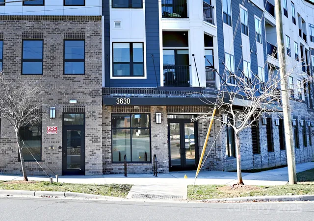 a view of a brick building with many windows