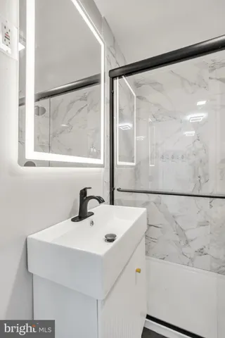 a bathroom with a sink and a large mirror