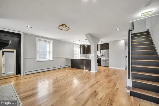 a view of kitchen and hall with wooden floor