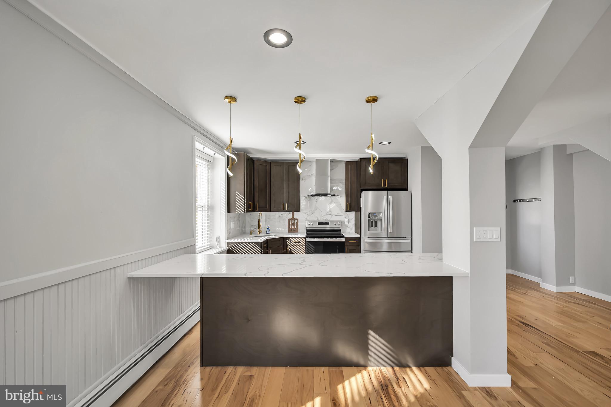 246 Cottage Avenue, Unit B Horsham, PA 19044 - Photo 5 of 19 a large kitchen with kitchen island granite countertop a refrigerator and a sink