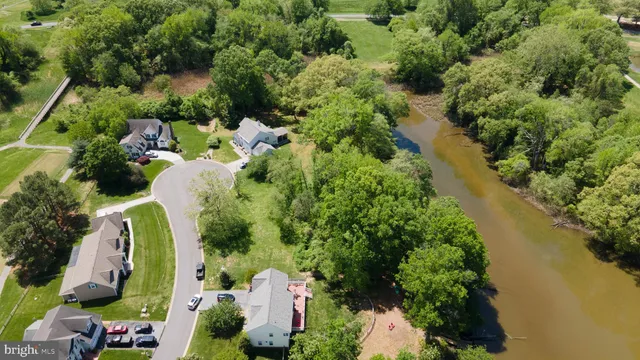 an aerial view of residential house with outdoor space and swimming pool