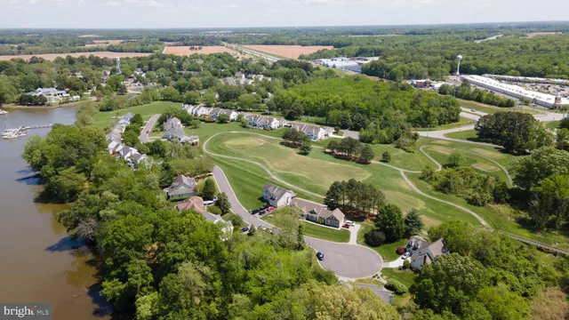 an aerial view of lake residential houses with outdoor space and swimming pool