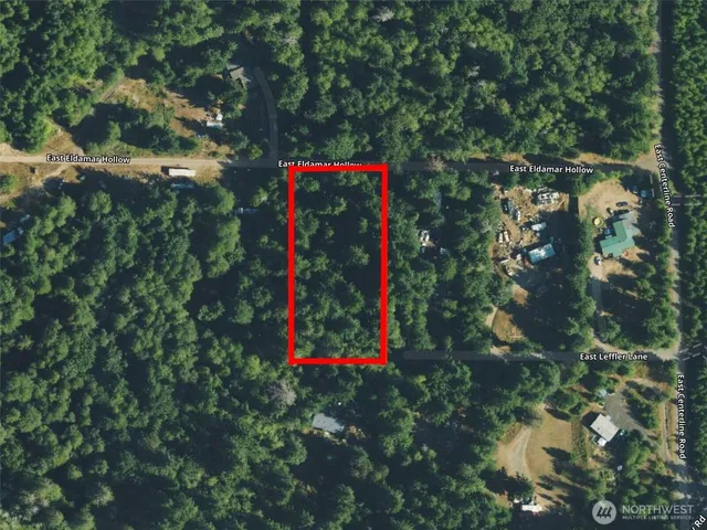 a sign that is sitting in a forest