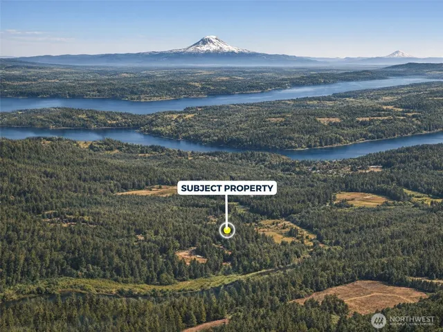 an aerial view of a residential houses with outdoor space and street view