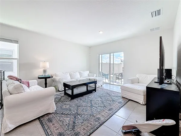 a living room with furniture and a lamp
