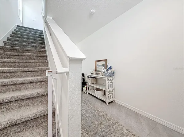 a bedroom with a bed lamp and a large window