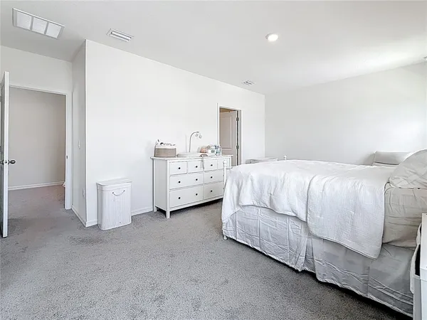 a spacious bathroom with a double vanity sink and a mirror