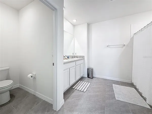 a view of a bedroom with bed and workspace