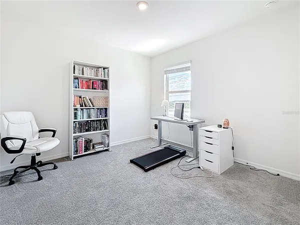 a bedroom with furniture a rug and a window