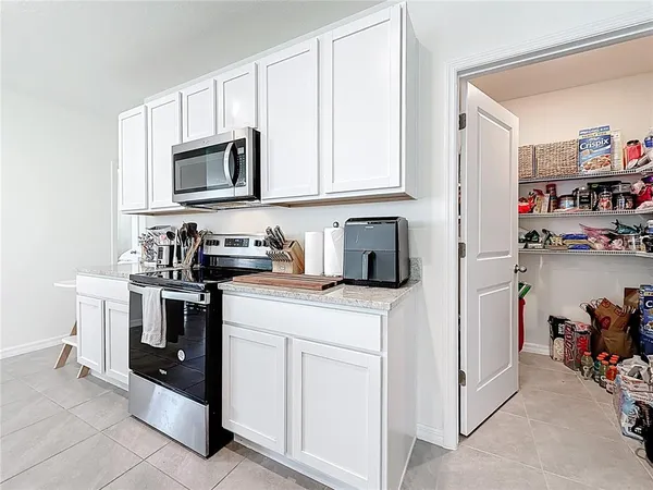 a kitchen with cabinets and appliances