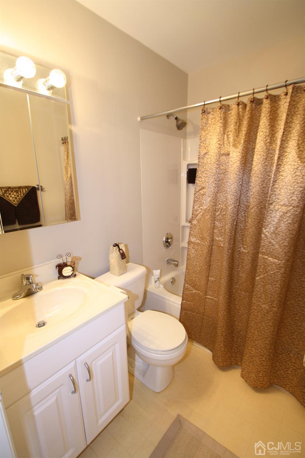 812 Robin Road Hillsborough, NJ 08844 - Photo 16 of 23 a bathroom with a sink a toilet a mirror a vanity and shower